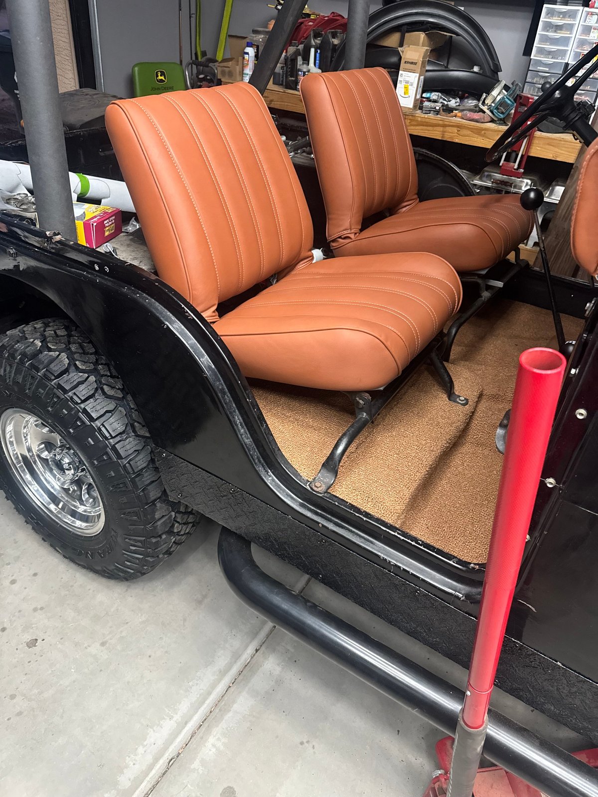 After: 1964 Jeep bucket seats reupholstered in burnt orange Morbern Allante vinyl, installed in the vehicle