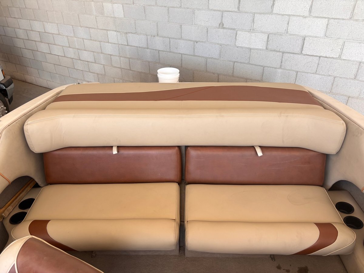 After: Sport boat interior with tan and brown Morbern Allante reupholstered sundeck, backrest, and bench seats installed